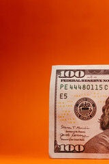 100 dollar bill with orange background