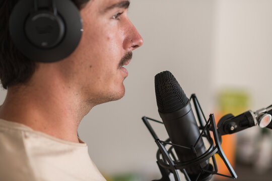 man recording a podcast at home