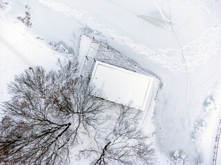 Aerial view. Winter landscape, snow, frost, ice, trees, alleys and paths, park. Sharp winter. 