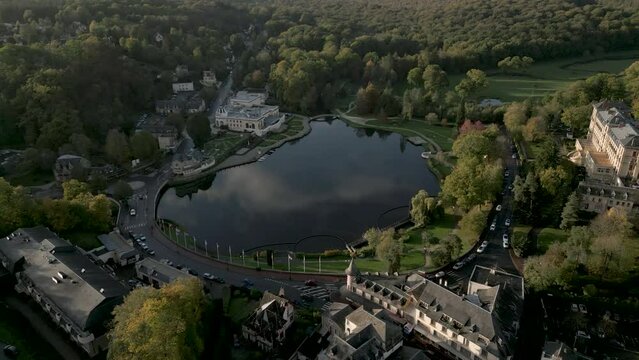 Lac de Bagnoles de l'Orne, small lake in bucolic and idyllic verdant landscape, Normandy in France. Aerial top-down forward