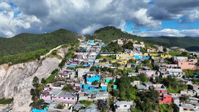 Aerial view of colorful mountain village of San Cristobal de Las Casas in Mexico. Clouds over the mountains. 