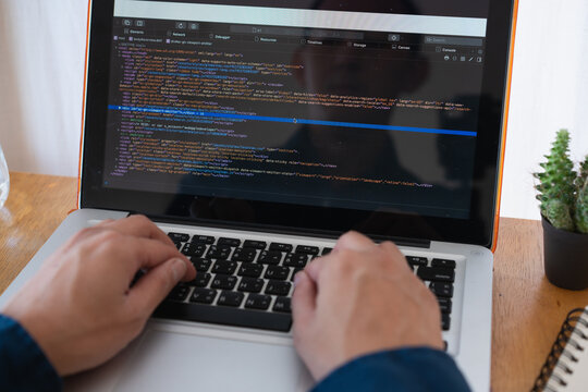 Programer developer coding software about intelligence innovation. Young man programmer writes program code on a computer. home office .
