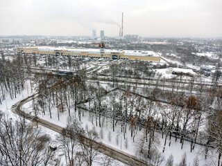 Aerial view. Winter cityscape. Trees, factory, chimneys, winter, forest, park, snow , frost, ice. 