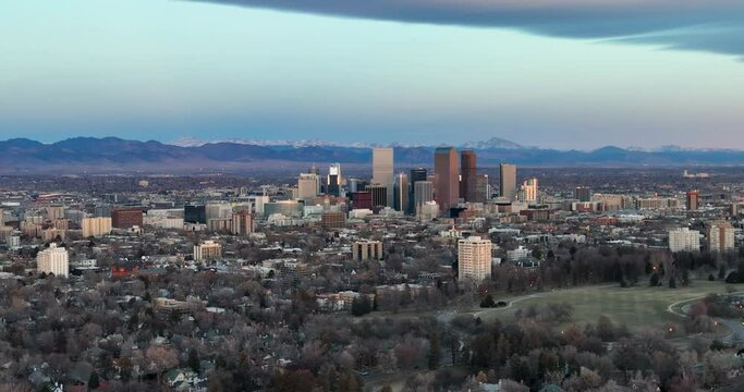 Aerial panorama of Denver downtown skyline in the winter season, snowy mountains in background