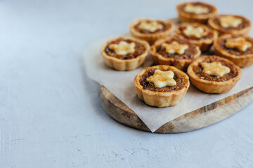 Christmas mince pies with fruit filling on a gray background.