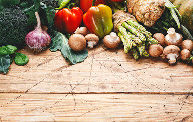 Food background with vegan cooking ingredients. Organic vegetables, pumpkin, mushrooms, asparagus,...