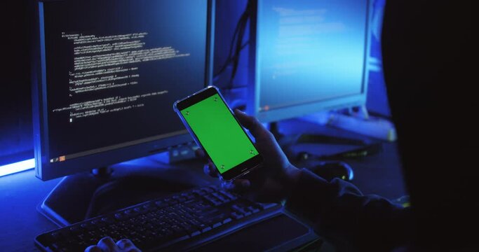 A male hacker is using a computer to hack data to demand ransom from victims.
