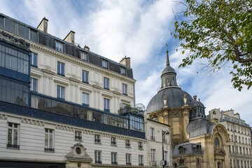 Fototapeta na wymiar Paris, typical buildings in the Marais, rue Saint-Antoine, with the Saint-Paul church 