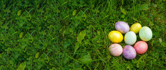 Multicolored eggs on the grass. Easter holiday tradition. Spring religious holiday.