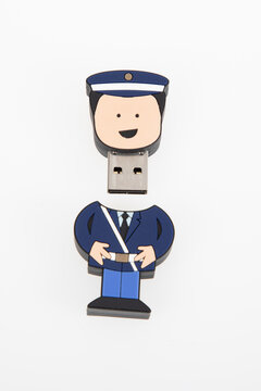 usb flash key drive shaped like cartoon policeman open lid on white background
