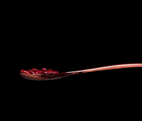 Red Bean fall, red grain beans explode abstract cloud fly from wooden spoon. Beautiful complete seed pea bean, food object design. Selective focus freeze shot black background isolated
