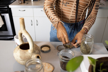 indigenous non-binary artist hands making tea in kitchen
