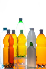 Various Empty Colorful Plastic Recycle Garbage Bottles and Cans In Line Together Over White Background.