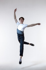 One Professional Caucasian Male Ballet Dancer Performing in Flight With Hands Outspread
