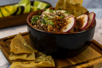 meat in its juice with golden tortilla, toasted, prepared with radishes and spicy sauces