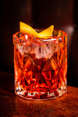 Negroni cocktail with orange peel and ice