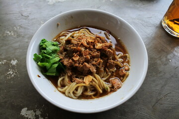 Indonesian authentic and traditional meatballs soup - Bakso soup on white cup and marble background