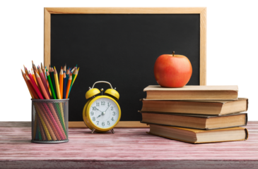 Stack of books with chalk blackboard and colored pencils on the wooden table.