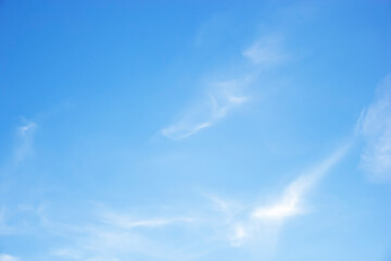 Blue sky background and white clouds soft focus, and copy space horizontal shape.