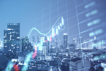 Creative glowing forex index chart/graph on toned dark city backdrop. Trade, finance and market concept Double exposure.