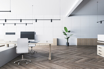 Front view on stylish cozy work place table with modern computer in spacious coworking office with wooden parquet floor and light wall background. 3D rendering
