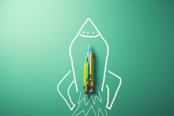 Modern pencils and rocket spaceship sketch on green background. Education, school and knowledge...