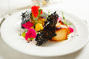 fish steak with puree on white plate