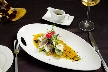 fish steak with puree on white plate