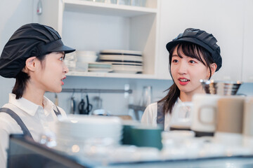 楽しく業務内容を教えてもらう飲食店アルバイトの女性