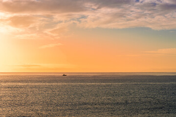 view at sunrise or sunset in sea with nice beach , surf , calm water and beautiful clouds on a background of a sea landscape