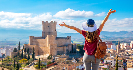 Atalya,Villena Castle in Costa Blanca Alicante Spain- woman tourist enjoying beautiful panoramic view - obrazy, fototapety, plakaty