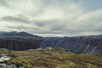 Large mountains on gloomy day landscape photo. Beautiful nature scenery photography with grey clouds on background. Idyllic scene. High quality picture for wallpaper, travel blog, magazine, article