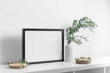 Horizontal frame mockup in white room with botanical decor, blank mockup with copy space