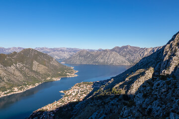Panoramic view of the bay of Kotor during sunrise in summer, Adriatic Mediterranean Sea, Montenegro, Balkan Peninsula, Europe. Fjord winding along the coastal towns. Lovcen and Orjen mountain range
