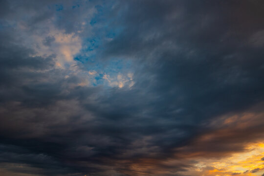 Dramatic cloudy sky background photo. Cloudscape at sunrise or sunset