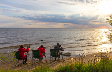 photographers on the lake shore. Onega Lake. Russia