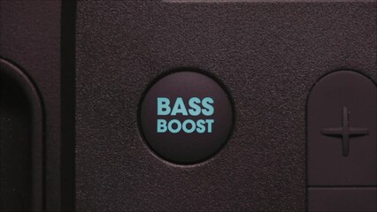 Macro shot of finger presses bass boost button lights up on the amplifier 4K