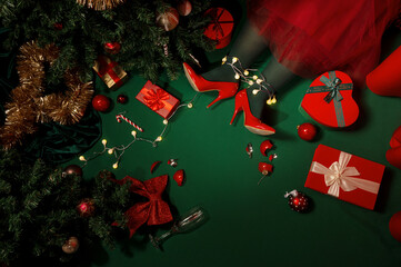 Christmas background with presents, Christmas tree and legs on green background with lights 