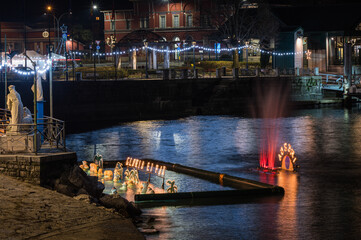 Christmas crib submerged and illuminated by colored lights in the water of Lake Maggiore in Laveno