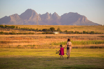 a girl with a child on the background of the mountains of the South African republic