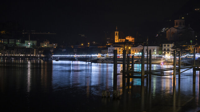 Night panorama of the lakefront of Laveno illuminated by many colored Christmas lights