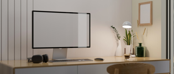 Comfortable working table with computer mockup and decor on wood table against the white wall