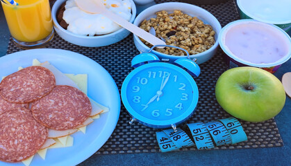 Alarm clock Intermittent fasting eight hour feeding window concept  which diet eating a healthy food background