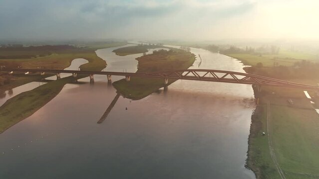 Hanzeboog train bridge over the river IJssel near the city of Zwolle in Overijssel, The Netherlands. Aerial drone point of view.