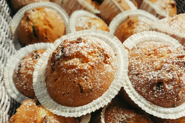 delicious chocolate muffins with powdered sugar in a basket
