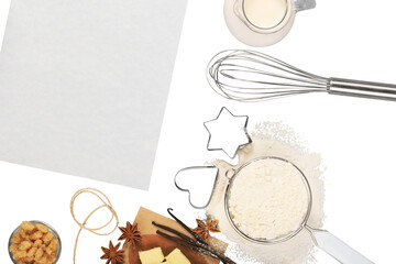 Wood kitchen table with a blank cook book and baking ingredients