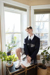 portrait of non-binary caucasian person with short brown hair at home
