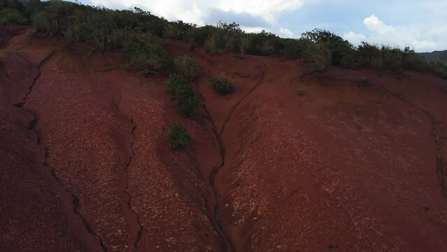 Aerial view around stunning viewpoint Mirador de Abrante with glass observation balcony above Agulo village in La Gomera island at sunrise. Red clay.
