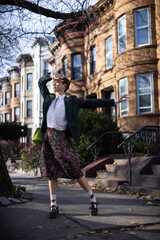 non-binary caucasian person with short hair dancing on Brooklyn sidewalk