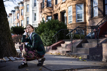 non-binary caucasian person with short hair posing on Brooklyn sidewalk